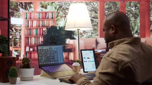 Adult Using Laptop and Tablet at Desk