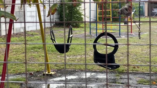 A broken swing in a kids play park in Cape Town, South Africa.