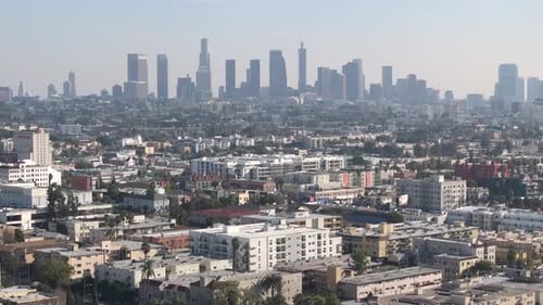 Aerial view of cityscape, residential neighborhood and downtown Los Angeles on a smoggy day