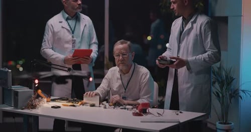 Scientists Working Late on Electronics Project in Lab