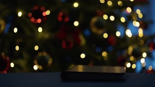 Glowing Book with Festive Christmas Tree Background