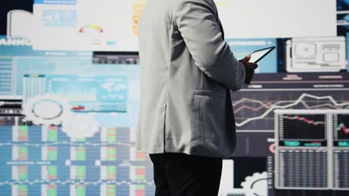 Black Male Entrepreneur Reviews Financial Graphs and KPI Models