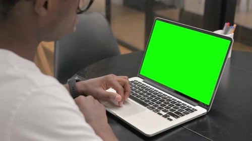 African Man Using Laptop with Green Screen