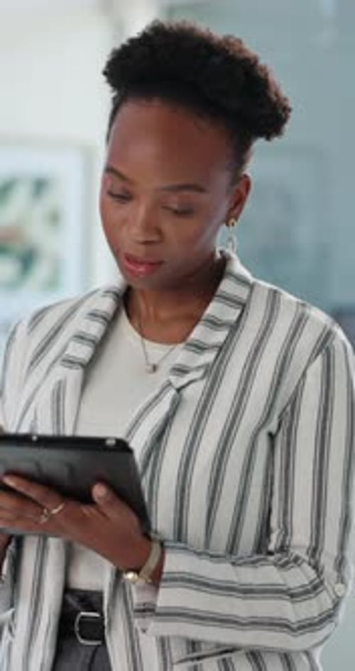 Black woman, tablet and typing at office with review, proposal or risk assessment at company