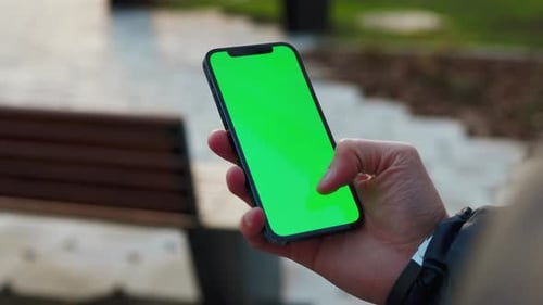 NEW YORK December 19 2020 Close Up Hands Man Use Phone with Vertical Green Screen Stand on Street