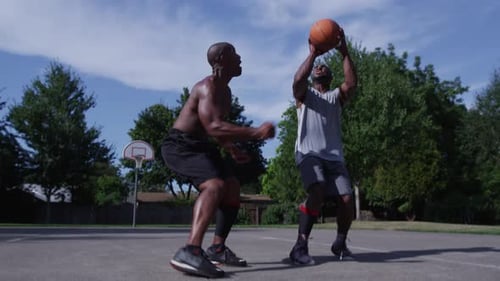 Street basketball athlete shoots and misses in energetic outdoor city game