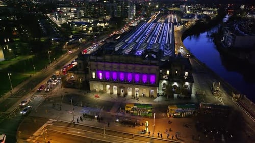 cinematic drone footage of Heuston Station in Dublin at sunset, highlighting the historic building,