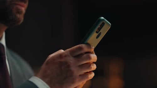 Manager Hand Texting Cellphone Screen Answering Email at Night Office Closeup