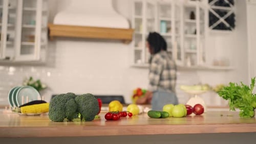 Woman Preparing Fresh Vegetables in Bright Kitchen