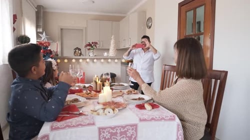 Family Toasting at Holiday Dinner Celebration at Home