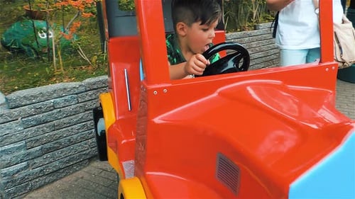 Cute Caucasian Boy Enjoying A Fun Ride At Carnival at Bakken Denmark