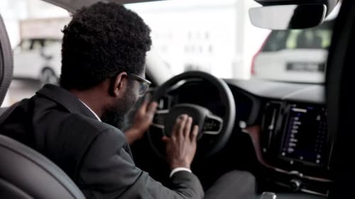 Businessman Buying Car and Sitting Inside Vehicle at Dealership