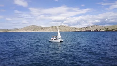 Catamaran Sailboat sailing on the Blue sea - Aerial Drone View