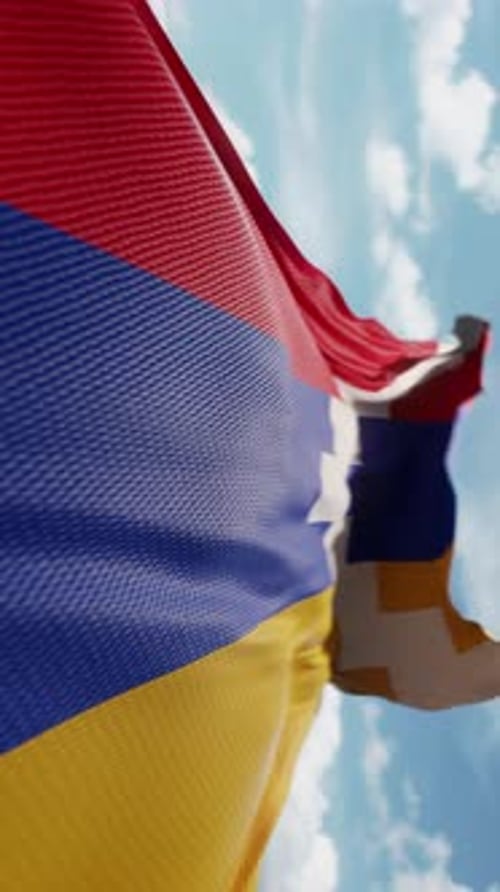 Waving Red Blue Yellow Flag with White Step Pattern Against Sky