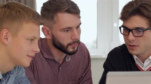 Team Discussing Project on Computer in Bright Office