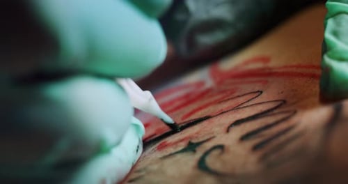Milan/Italy-01.02.2019:Slow motion of professional master of the art of tattooing doing a tattoo t