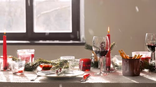Festive Table Setting with Wine and Burning Candles
