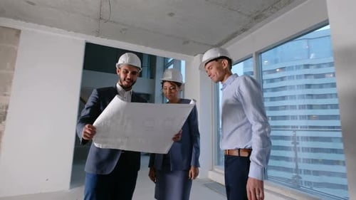 Group of Construction Workers Checking Building