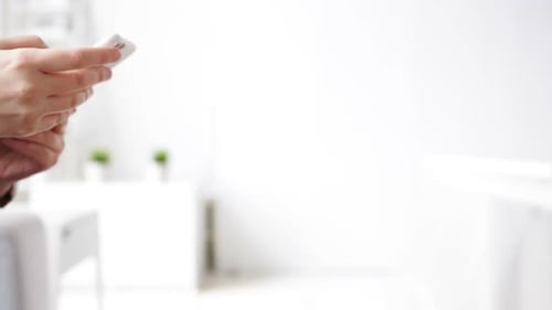 Woman's Hands Using Mobile Phone in Bright Room