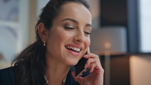 Business Woman Talking on Phone in Office Setting