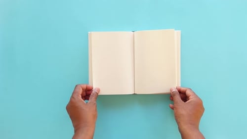 Top View of Man's Hand Turning a Pager of a Diary