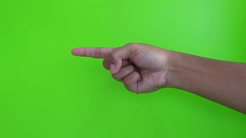 Asian hand showing index finger gesture on green background. hand gesture pointing at something