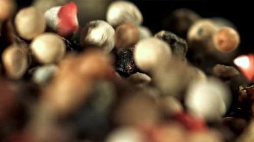 Macro Shot of Falling Colorful Peppercorns and Spices