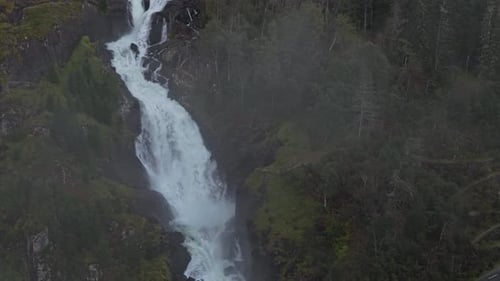 Aerial landscape with Latefossen waterfall and winding road