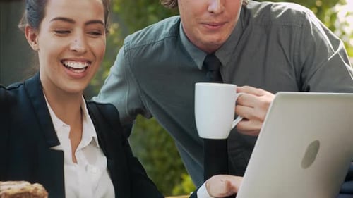 Business Colleagues Working Together on Laptop with Coffee