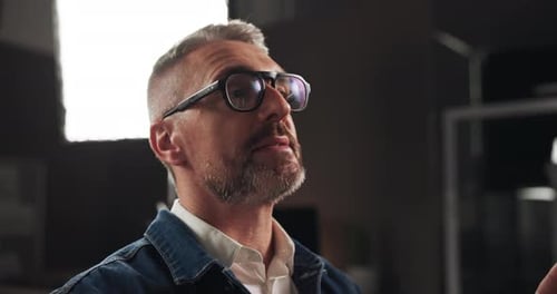 Talking, interview and man in studio for filming with documentary, show or movie on set