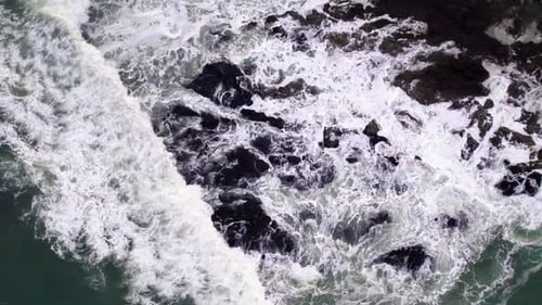 Abstract Top Down Foamy Ocean Waves Crashes Rock