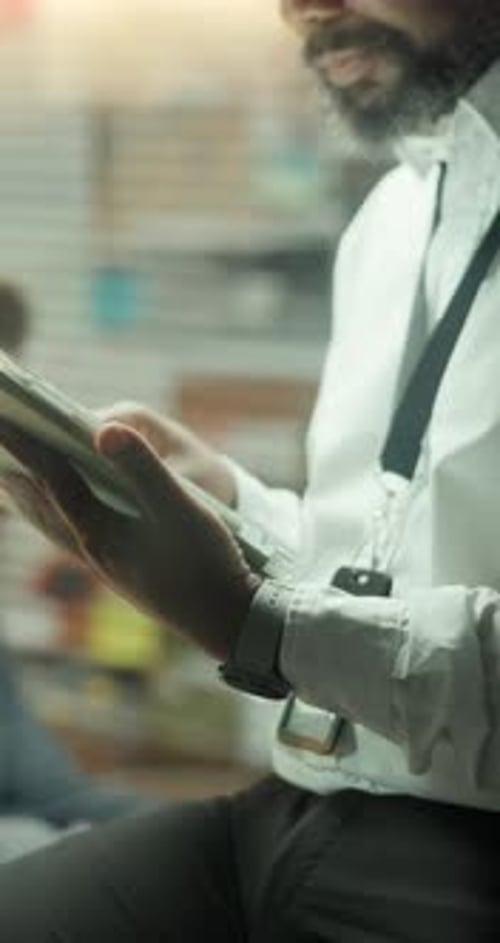 Man Uses a Tablet Device in an Office