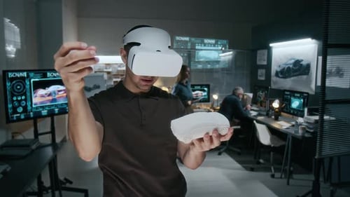 Male Automotive Engineer in Augmented Reality Headset Working with Clay Model