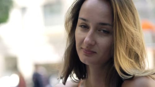 Happy, Pretty Woman Drinking Wine Sitting in Cafe in City 30s