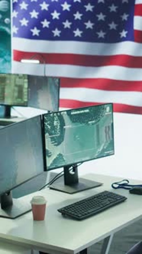 Computer Screens in an Office with US Flag