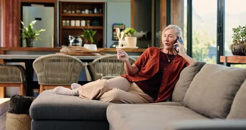 Mature Woman Chatting on the Phone at Home
