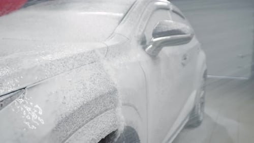 Highpressure Foam is Applied to Automobile for Touchless Washing Side View At Car Wash They Wash Car