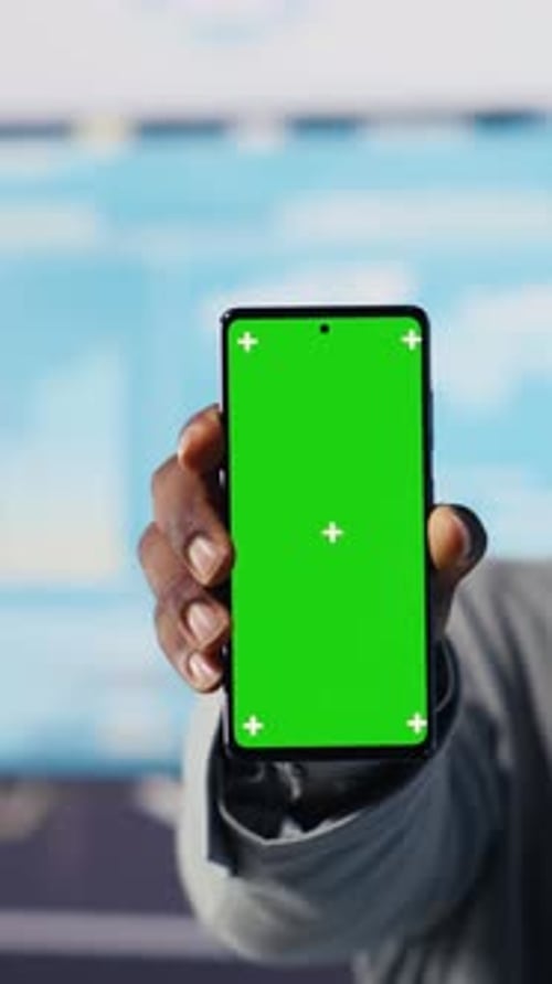 Vertical Video African American Administrator Uses Copy Space on Phone and Examines Dashboards