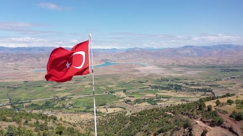 Turkish Flag Waving over Scenic Landscape