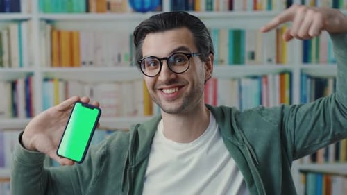 A Thoughtful Man Seated in a Modern Library Setting Surrounded By Books and Knowledge