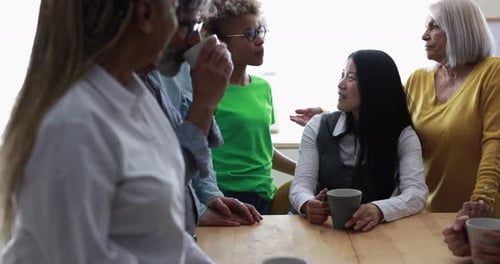 Diverse group of friends talking over coffee