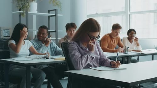 Diverse Students Engaged in Focused Study Session at College Classroom