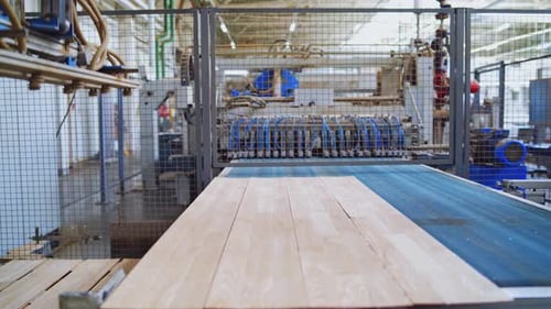 Modern wooden industry. Robotic machine working on a factory for producing wooden laminate.