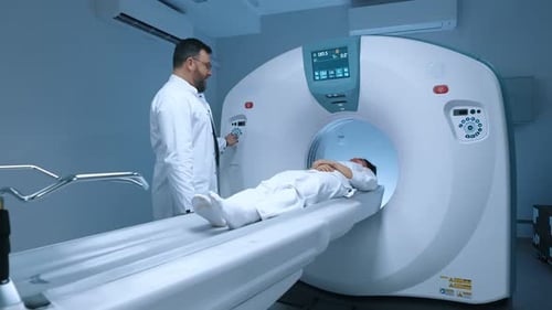 Man Operates CT Scanner With Patient Inside