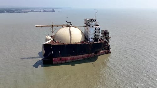 Epic cinematic aerial shot of a large ship abandoned in a ship graveyard in Bangladesh