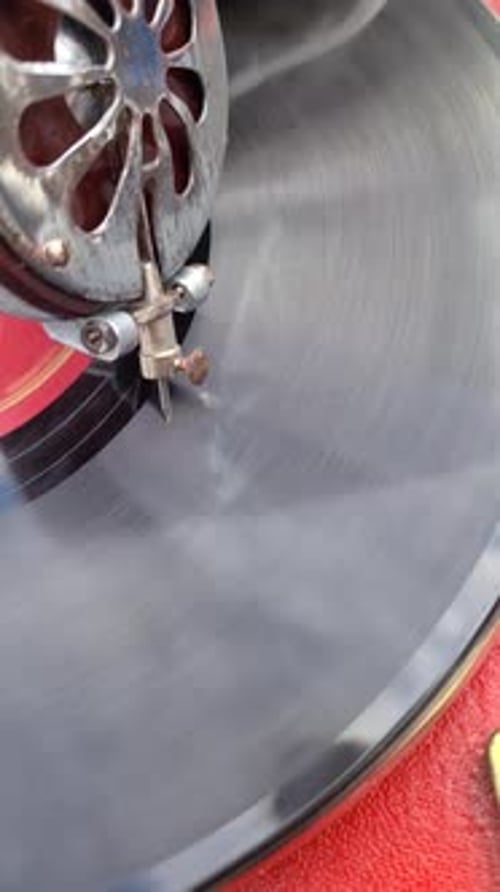Detailed Closeup of a Turntable Needle Gliding Over a Spinning Record