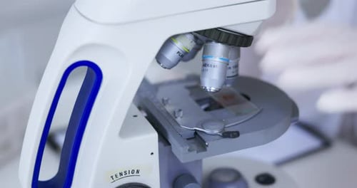 Close Up of Scientist Using Microscope in Lab