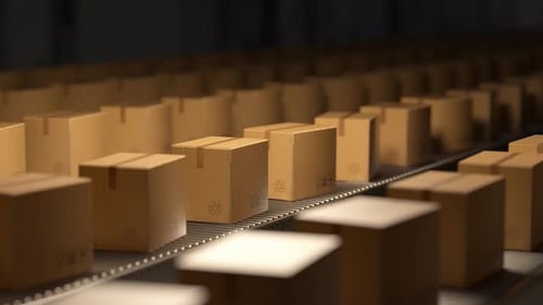 Cardboard boxes moving on a conveyor belt in a warehouse