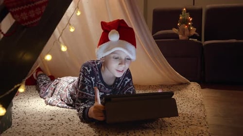 Boy Using Tablet in Christmas Tent at Home