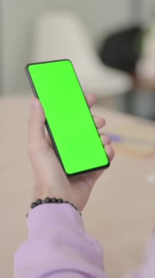 Rear View of Man using Smartphone with Green Chroma Screen, Vertical Video